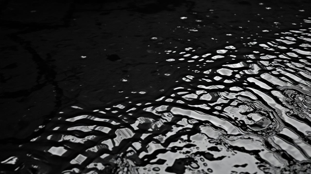 Black and white rippling stream water surface